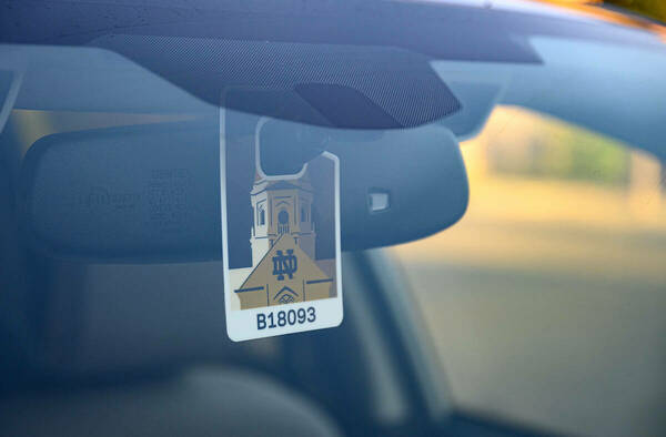 Notre Dame parking hangtag hanging from a rearview mirror