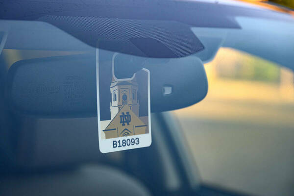 Notre Dame parking hangtag hanging from a rearview mirror