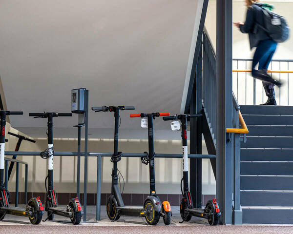 Electric Scooters parked next to a stairway