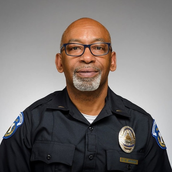 Police officer Andre Bridges in uniform with a gray background